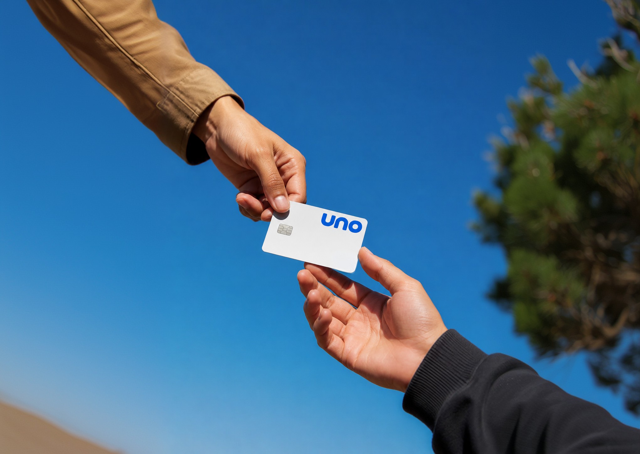 Two people exchanging an Uno card