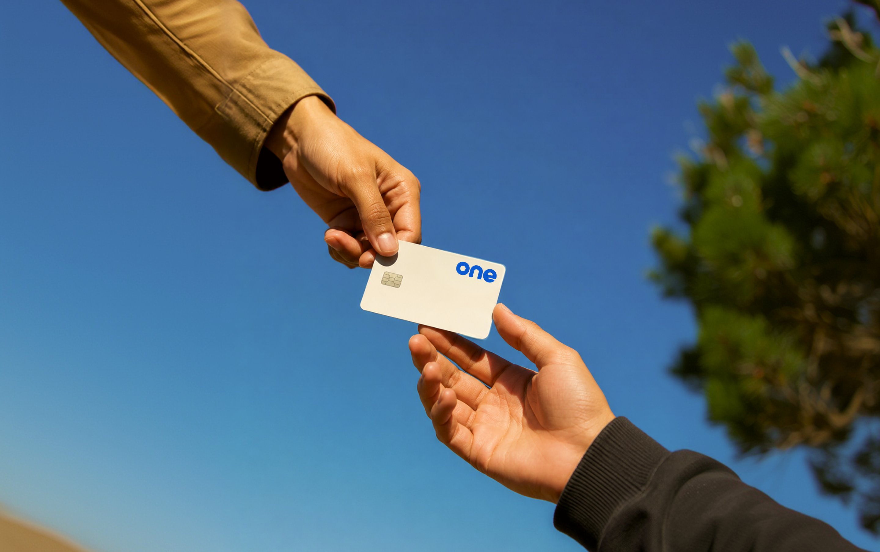 Two people exchanging an Uno card